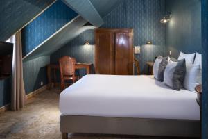 a bedroom with a white bed and blue walls at Elysées Hôtel in Paris +42 photos