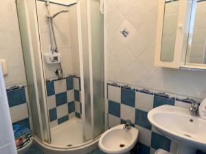 a bathroom with a sink and a shower and a toilet at Ponzamania Casa dei fiori in Ponza +59 photos