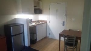 a small kitchen with a table and a sink at Studio 6 Extended Stay - Richmond, VA - I-64 West in Sweet Briar Park