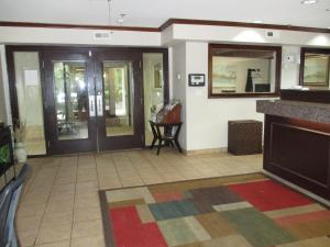 a lobby with glass doors and a tile floor at Studio 6 Extended Stay - Richmond, VA - I-64 West in Sweet Briar Park