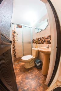 a bathroom with a toilet and a sink at Índigo Cowork in San Rafael +23 photos