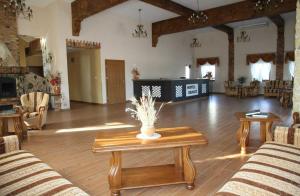 a large living room with a table and chairs at Hotel Dukat in Dębsk