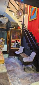 a room with two chairs and a spiral staircase at Madrid Centro, Edificio Entero Solo Para Ti in Madrid