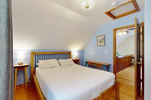 a bedroom with a large white bed and blue walls at 205 Town Hall Road in Lower Bartlett
