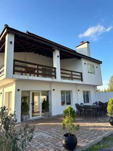 a large white house with a table and chairs at Hotel Boutique El Eden in Ranchos
