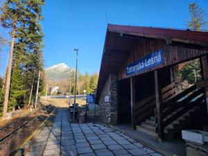a train station with a mountain in the background at Penzión ERIKA in Vysoké Tatry +27 photos