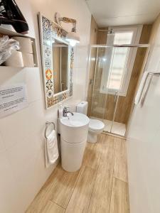 a bathroom with a sink and a toilet at Apartamento Vive Zaragoza in Zaragoza +16 photos