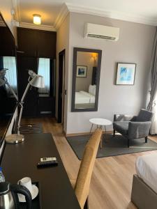 a living room with a bed and a desk in a room at The Sojourner By Genesis in Ikeja