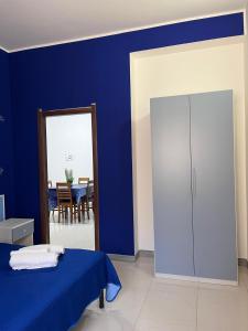 a blue room with a bed and a cabinet at B&B Andromeda in Palmi +23 photos