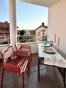 a balcony with a table and two chairs and a view at Apartments Terra Solaris in Medulin