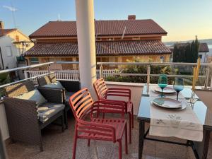 a patio with a table and chairs on a balcony at Apartments Terra Solaris in Medulin