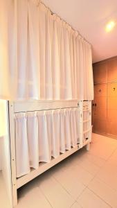 a room with white curtains in a kitchen at WeStay Ladies Hostel in Dubai