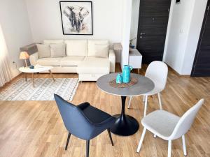 a living room with a couch and a table and chairs at Apartments Terra Solaris in Medulin