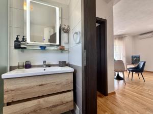 a bathroom with a sink and a mirror at Apartments Terra Solaris in Medulin