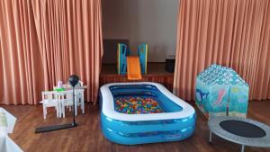 a childs play room with a toy pool and chairs at MäuseScheune in Sankt Annen