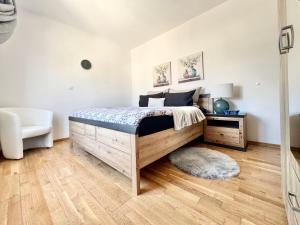 a bedroom with a bed and a white wall at Apartments Terra Solaris in Medulin