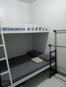 a room with two bunk beds and a ladder at Bahay Ko 2 transient home in Sariaya in Sariaya