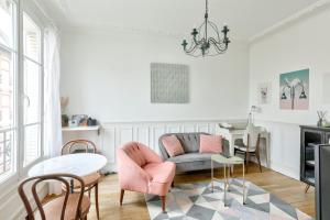 a living room with a couch and a table at GuestReady - Serene Stay near Paris in Bois-Colombes