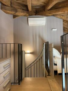 a staircase leading up to a bedroom with a bed at Dimora Rosaspina in Adro