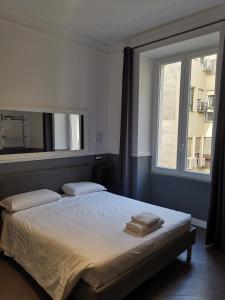 a bedroom with a bed with two towels on it at I LOVE ROMA Guest House in Rome