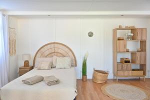 a bedroom with a large bed with towels on it at La Maison du Bonheur, Piscine, Jacuzzi, Billard in Le Grau-du-Roi +55 photos