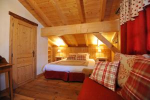 a bedroom with a bed in a room with wooden ceilings at Grand Chalet - Coeur de la montagne in Mont-Saxonnex +12 photos