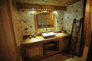 a bathroom with a sink and a mirror at Grand Chalet - Coeur de la montagne in Mont-Saxonnex