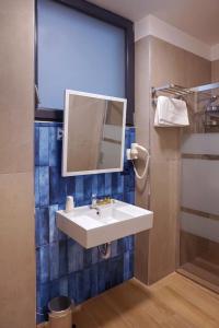 a bathroom with a white sink and a mirror at Hotel Garden in Rivoli +10 photos