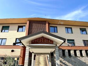 a brick building with a staircase in front of it at Hotel Garden in Rivoli