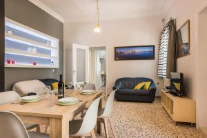 a living room with a dining table and a couch at Geana Apartments in Chania