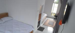 a bedroom with a bed and a television in it at CC Roomstay Kampung Mangkuk, Terengganu in Setiu