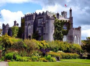 an old castle with a garden in front of it at Deerpark Stables in Highstreet