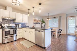 a kitchen with stainless steel appliances and a dining room at 4 Beds! Walk to Town! Grnd Floor Condo, Modern, Summer AC in Leavenworth +18 photos