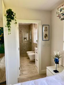 a bathroom with a tub and a toilet and a sink at Deerpark Stables in Highstreet