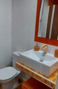 a bathroom with a white sink and a mirror at La casa de San Miguel in Villalpando