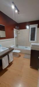 a bathroom with a shower and a sink and a toilet at La casa de San Miguel in Villalpando