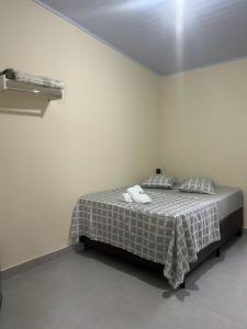 a bedroom with a bed in a white room at Pousada Santa Rita in Roseira +7 photos