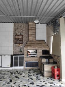 a kitchen with a staircase in a room at Pousada Santa Rita in Roseira