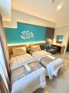 Ένα ή περισσότερα κρεβάτια σε δωμάτιο στο RASS Horizon Suites