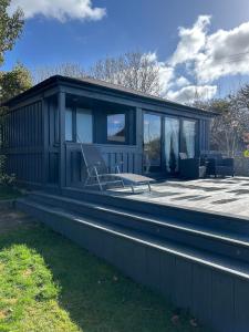 a house with a bench and a chair on the roof at Stylish Cabin in East Sussex near Newhaven ferry in Newhaven