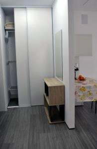 a room with a table and a bed and a mirror at Cozy Seaside Studio Apartment C - Faraway in Lagoa +7 photos