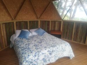 a bedroom with a large bed in a tent at Ecobindu-Domo in Albán
