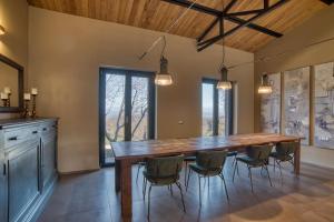 a dining room with a large wooden table and chairs at Tuscan Cozy Escape with View, Garden & Breakfast in CastellʼAzzara