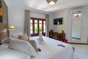 Uma TV ou centro de entretenimento em Terra Boa Hotel Boutique