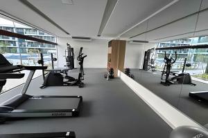 a gym with treadmills and ellipticals in a building at Flat Luxo Alto Padrão, Praia de Muro Alto, Makia Beach Experience in Ipojuca