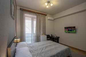 Postel nebo postele na pokoji v ubytování Seasons Boutique Hotel