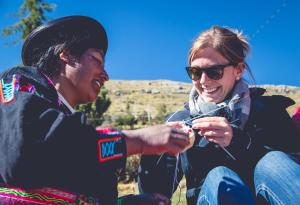 a woman sitting next to a man holding a kite at HOSPEDAJE DON FERNANDO - Luquina Chico in Puno