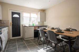 a kitchen with a table and chairs and a kitchen with a counter at The Rise Retreat in Livingston