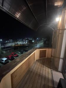 a balcony with cars on a parking lot at night at LaWanda Studio in Petroşani