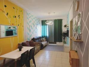 a living room with a couch and a table at Barakah Sufi Home Stay Apartment Cameron in Tanah Rata